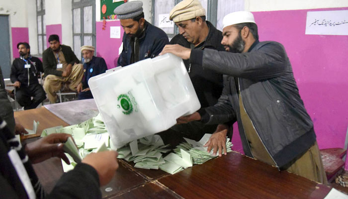 Polling officials open ballot boxes to count the votes at the polling station Government Sardar Schoo Garhi Shahul during the General Election-2024 on February 8, 2024. — APP