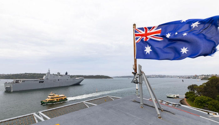 This handout photo taken and released by the Royal Australian Navy and the Australian Defence Force on January 18, 2022, shows the defense is pre-positioning HMAS Adelaide to Brisbane. — AFP/File