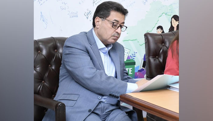 Chief Election Commissioner (CEC) Sikandar Sultan Raja looks at a document during a meeting on July 5, 2023. — Facebook/Election Commission Of Pakistan - ECP