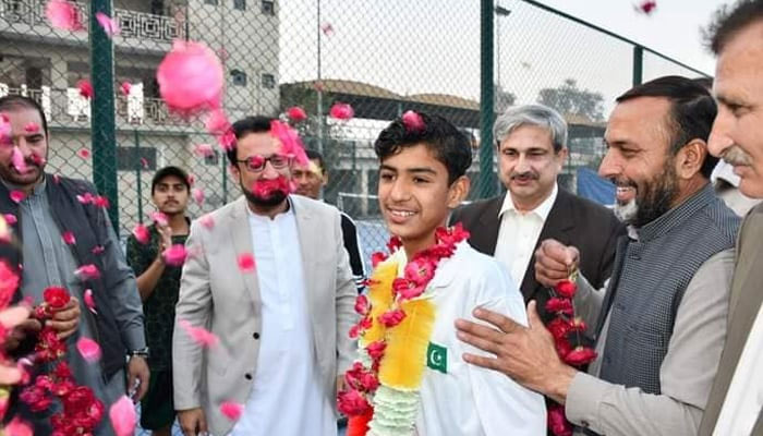 Pakistans junior Tennis player Hamza Roman can be seen being welcomed by his family. — PTF