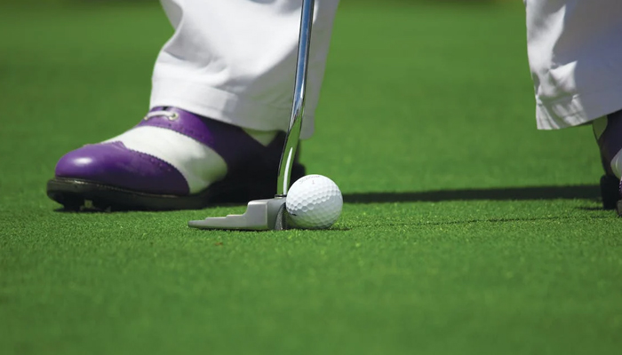 A representational image of a person while playing golf. — Pexels