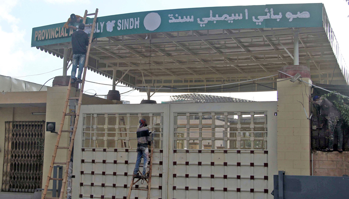 Labourers are busy in the paint of the main gate of Sindh Assembly ahead of oath taking ceremony of newly elected members of the Sindh Provincial Assembly, in Karachi on February 20, 2024. — Online