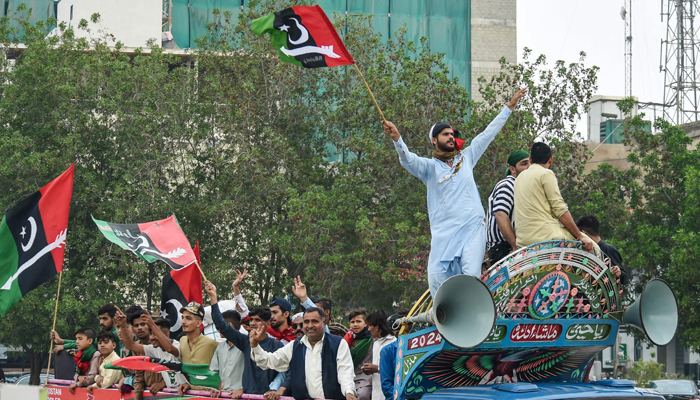 Supporters of the Pakistan Peoples Party (PPP) wave the partys flag during an election campaign rally in Karachi on February 5, 2024. — AFP