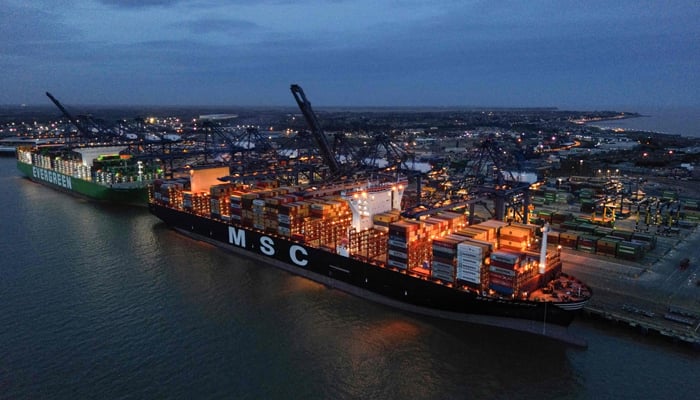 An aerial picture shows stacks of containers pictured on the deck of the MSC Allegra (R) and Ever Atop (L) container ships, docked beside container cranes at the UK´s largest freight port, in Felixstowe on the East coast of England, on January 27, 2024. — AFP