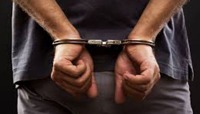 A representational image of a handcuffed man. — APP