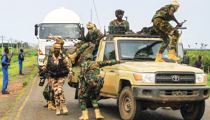 Fighters accompanying the governor of Sudan’s Darfur State exit a vehicle during a stopover in the eastern city of Gedaref. — AFP/File
