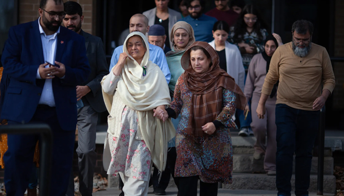 Family and friends of the Afzaal family, including Tabinda Bukhari, centre-left, the mother of Madiha Salman, exit the Superior Court of Justice in Windsor, Ont., after a verdict in the Nathaniel Veltman murder trial on Nov. 16, 2023. — The Canadian Press/Dax Melmer