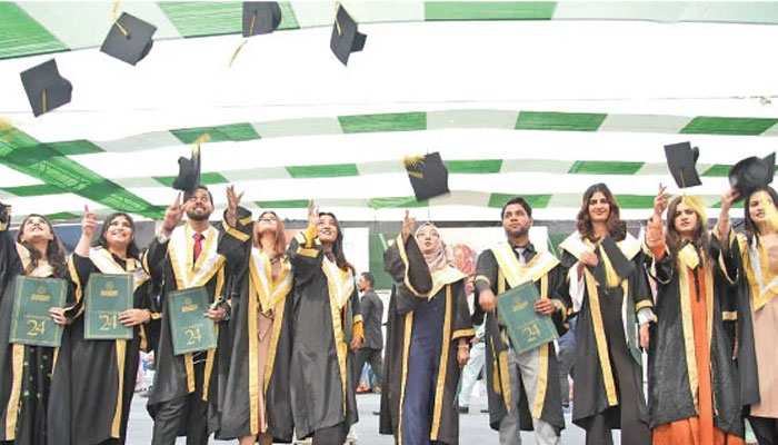 Graduates fling their caps into the air at the 21st convocation of Ziauddin University, which awarded 1,091 degrees in various disciplines on Saturday. — The News/Shoaib Ahmed
