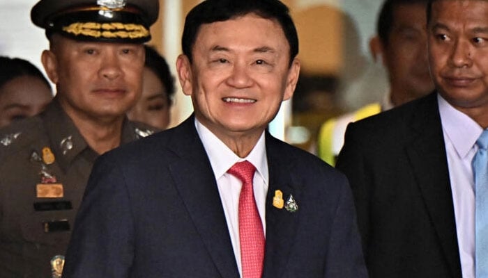 Former Thai prime minister Thaksin Shinawatra arrives to greet his supporters after landing at Bangkoks Don Mueang airport on August 22, 2023. — AFP