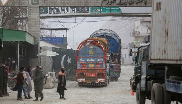 Goods carrier trucks cross into Pakistan at the zero point Torkham border crossing between Afghanistan and Pakistan, in Nangarhar province on February 25, 2023. AFP