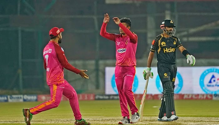 Shadab Khan (left) is excited after an Islamabad United bowler takes a wicket during a PSL match against Peshawar Zalmi in Karachi, on February 23, 2023. — PSL