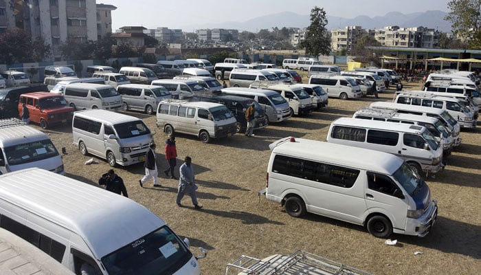 Vehicles stand in the grounds of a school for members of polling staff to carry polling material for the general election, in Islamabad on February 7, 2024. — Online
