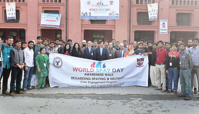 Participants hold a banners and posses for World Spay Day on February 27, 2024. — UVAS Webiste