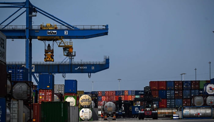 Containers are loaded onto trucks at the seaport terminal DIT Duisburg Intermodal Terminal at the Duisburg harbour on July 13, 2023. — AFP