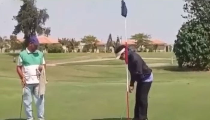 Golfer Bushra Fatima plays golf in Karachi in this still taken from a video. — Geo News
