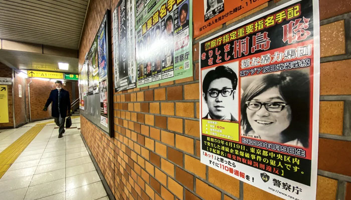 This picture taken on 26 January 2024 in a train station in Chuo district in Tokyo shows a poster of Satoshi Kirishima, who was a member of The East Asia Anti-Japan Armed Front, a radical leftist organization responsible for bombing attacks in Japans capital in the 1970s. — AFP