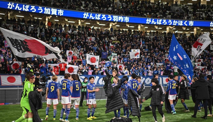 Japans players celebrate their 2-1 victory after the 2024 Olympic qualifying womens football match between Japan and North Korea at the National Stadium in Tokyo on February 28, 2024. — AFP