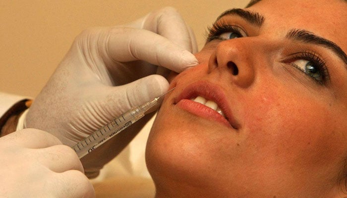 This image shows, a woman injected in her face. — AFP/File
