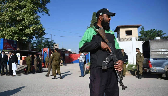 Police officials stand guard outside the Adiala Jail in Rawalpindi on October 23, 2023. — AFP