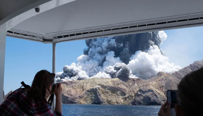 A person takes photos of volcanic eruption at New Zealands Whakaari, or White Island, Dec. 9, 2019. — Xinhua
