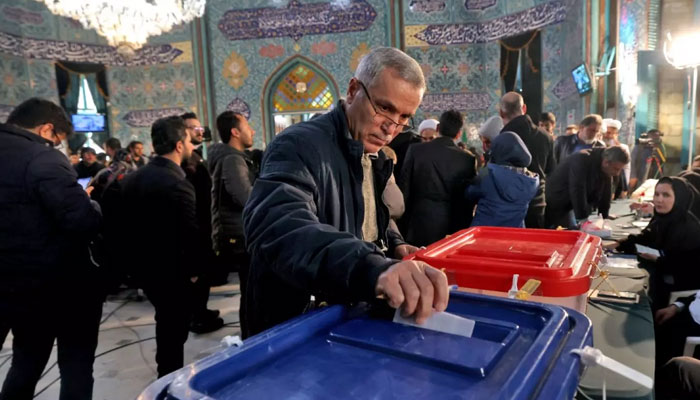 An Iranian man casts his ballot at a polling station in Tehran, during elections to select members of parliament and a key clerical body, on March 1, 2024. — AFP