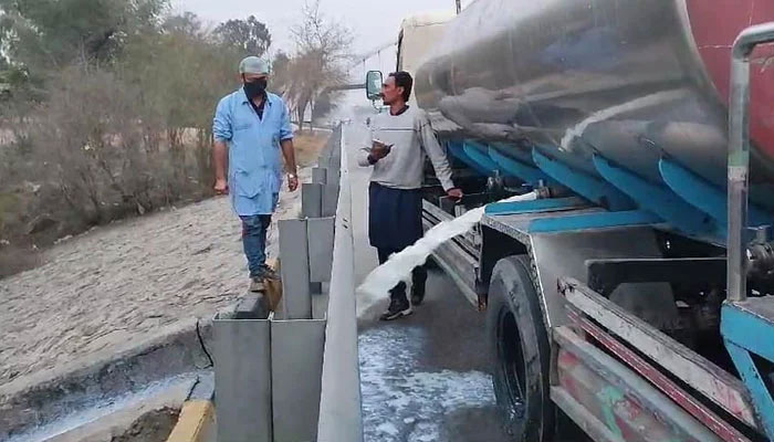 IFA workers disposing of substandard milk in the drain on February 17, 2024. — Facebook/Islamabad Food Authority