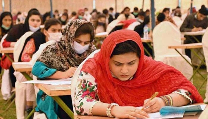 Students take an entrance exam. — APP/File