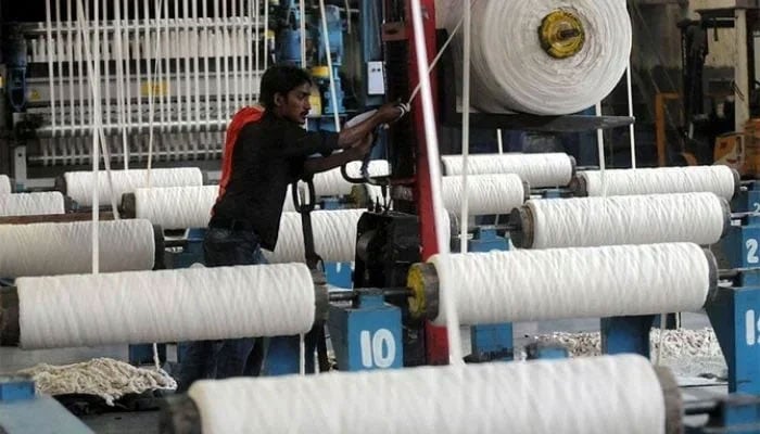 An employee working at a textile factory in Karachi in this undated file image. — AFP