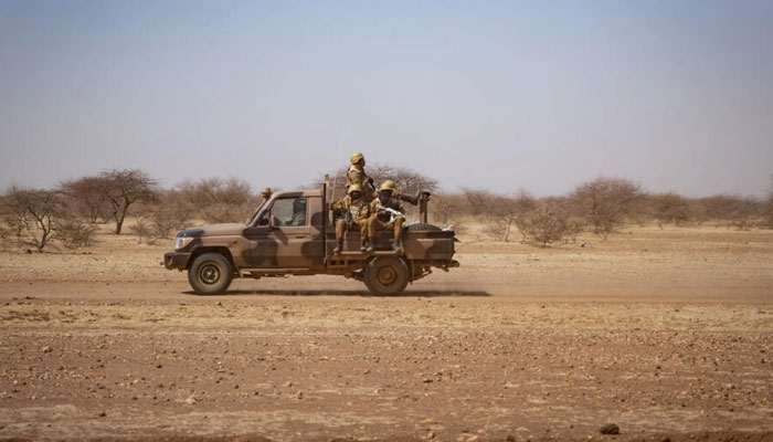 Burkina Faso soldiers patrol aboard a pick-up truck on the road from Dori to the Goudebo refugee camp, in the countrys restive north. — AFP/File