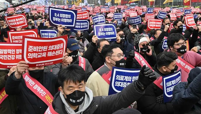 Doctors hold up placards reading Opposition to the increase in medical schools during a rally against the governments plan to raise the annual enrolment quota at medical schools, in Seoul on March 3, 2024. — AFP