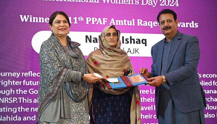 Chairperson National Commission on the Status of Women (NCSW) Nilofar Bakhtiar (left) and CEO Pakistan Poverty Alleviation Fund (PPAF) Nadir Gul Barech distributes Amt ul Raqeeb Awards during National Women Conference at the National Library on March 4, 2024. — APP