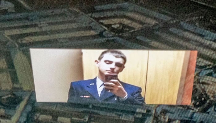 An illustration picture of National Guardsman Jack Teixeira reflected in an image of the Pentagon in Washington, D.C. — AFP/File