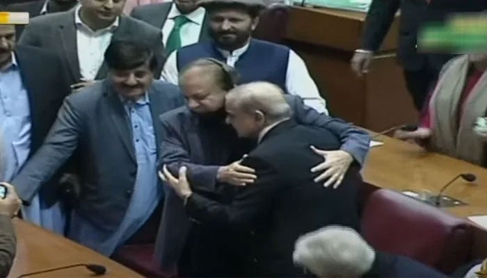 Shehbaz Sharif hugs his brother PML-N supremo Nawaz Sharif after being announced winner of the election for the prime minister. — Screenshot/Geo News