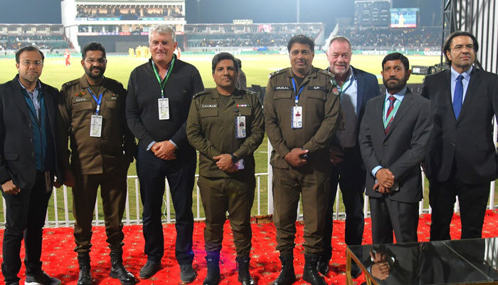 The two-member New Zealand security team stands along with Security and PCB officials. — Facebook/Pakistan Cricket Team/File