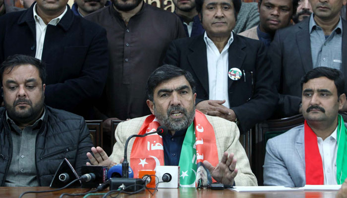 PTIs NA Member from NA-1 Chitral, Abdul Latif (centre) speaks during a press conference regarding rigging and illegal allocation of certain seats by the ECP, at Peshawar press club on March 6, 2024. — PPI