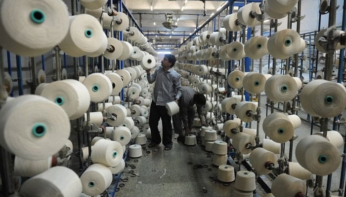 In this image, a man can be seen working in a textile factory in Pakistan. — AFP/File