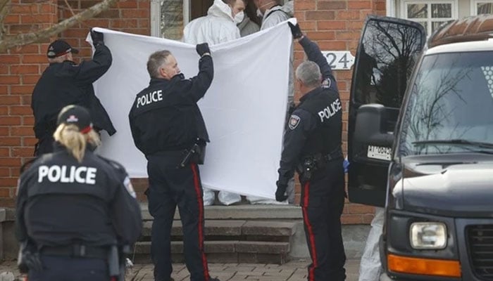 Coroners remove the bodies of six people, including four children, at a home at 324 Berrigan Drive in Barrhaven on Thursday, March 7, 2024. — Postmedia