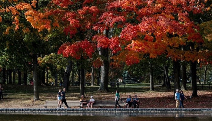 People walk near the Lac-aux-Castors at Mont-Royal in Montreal, Quebec, Canada, on October 05, 2023. –AFP