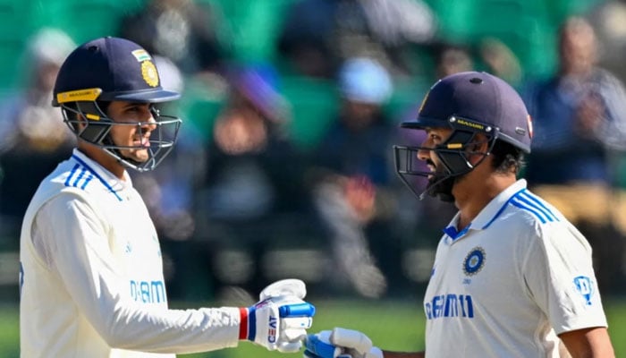India captain Rohit Sharma (right) bumps fist with Shubman Gill during the second day of their fifth Test against England in Dharamshala, India on March 8, 2024. — AFP