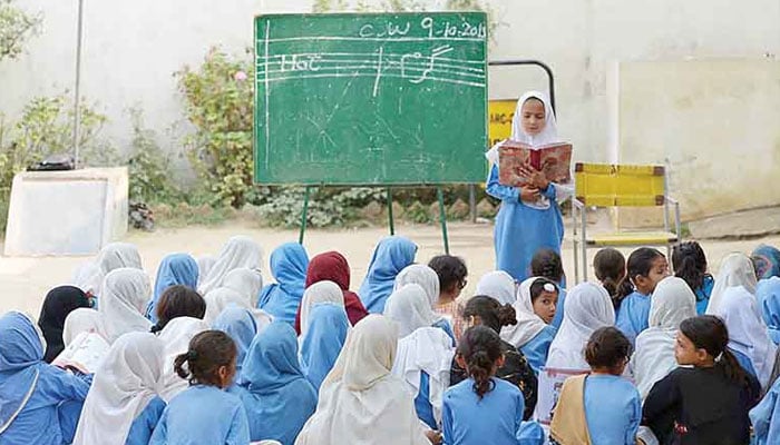 The undated image shows female students studying in an open-air classroom. — TNS/File