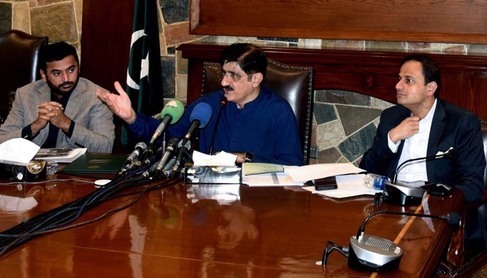 Sindh Chief Minister, Syed Murad Ali Shah (centre) sitting alongside Karachi Mayor Murtaza Wahab (right) speaks to media persons during a press conference at CM House in Karachi on Friday, March 8, 2024. — PPI