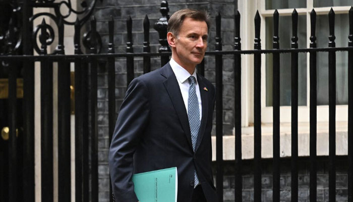 UK Chancellor Jeremy Hunt leaves Downing Street in central London on his way to make a full budget statement in the House of Commons on Nov. 17, 2022. — AFP