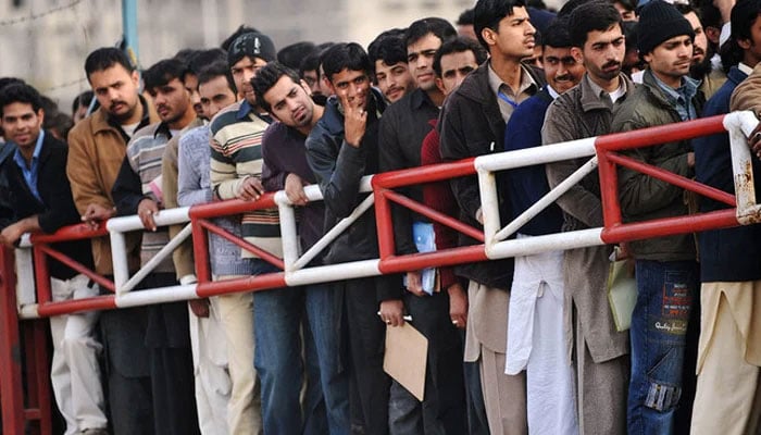 This representational image shows Pakistani youth wait for their turn for  job entry test. — AFP/File