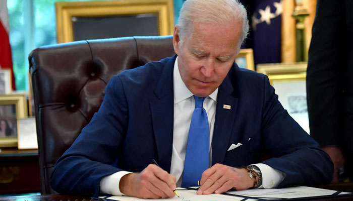 President Biden signs into law the Ukraine Democracy Defense Lend-Lease Act of 2022 in the White House. — AFP/File