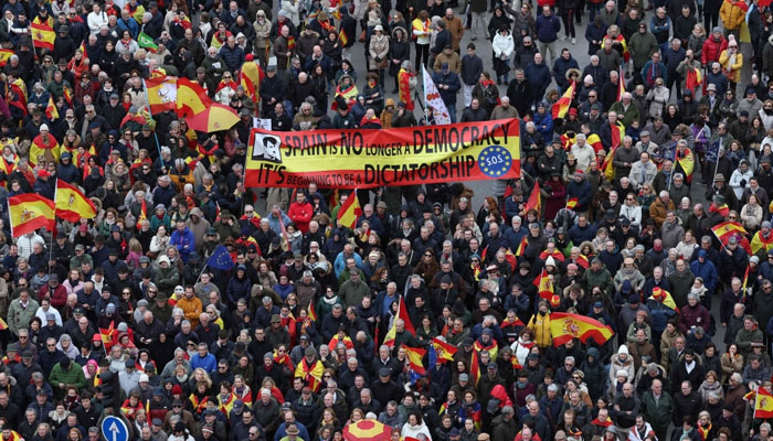 Protestors hold a banner reading Spain is no longer a democracy. Its beginning to be a dictatorship. SOS Europe during a protest on March 9, 2024. — AFP/File