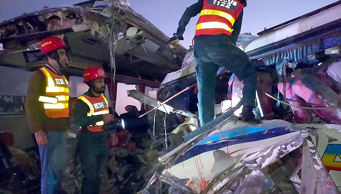 In this undated image, rescue workers are trying to find the injured after the accident. — Radio Pakistan/File