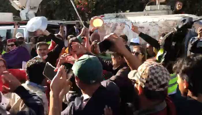 A clash takes place between people during the Aurat March in Islamabad, on March 8, 2023, in this still taken from a video. — Geo News