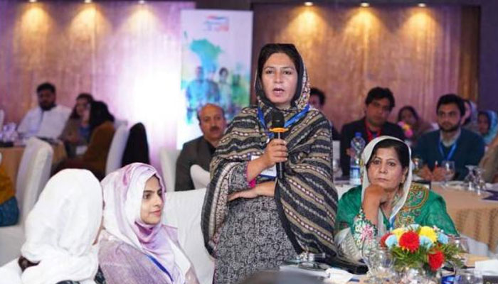 A woman speaks during a event. — APP/File