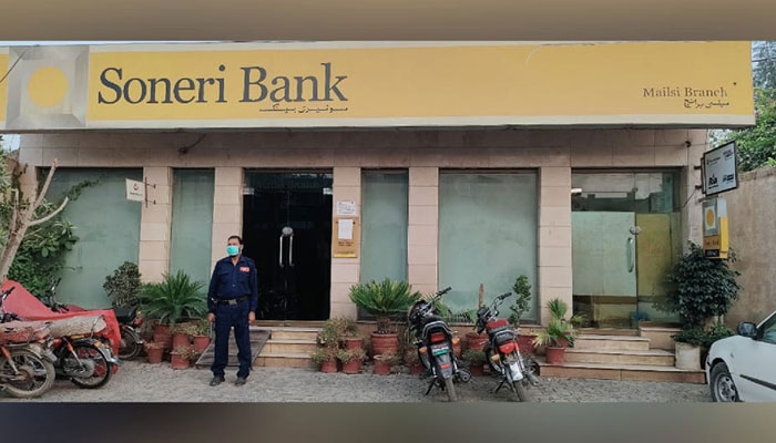 Security personnel stands outside the Soneri Bank Branch this image released on July 13, 2022. — Facebook/Soneri Bank Mailsi branch
