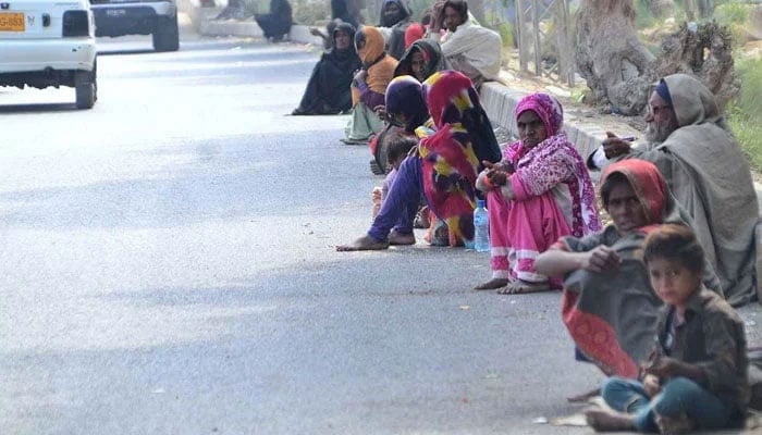 A large number of beggars sitting on the roadside waiting for alms on February 10, 2022. — APP